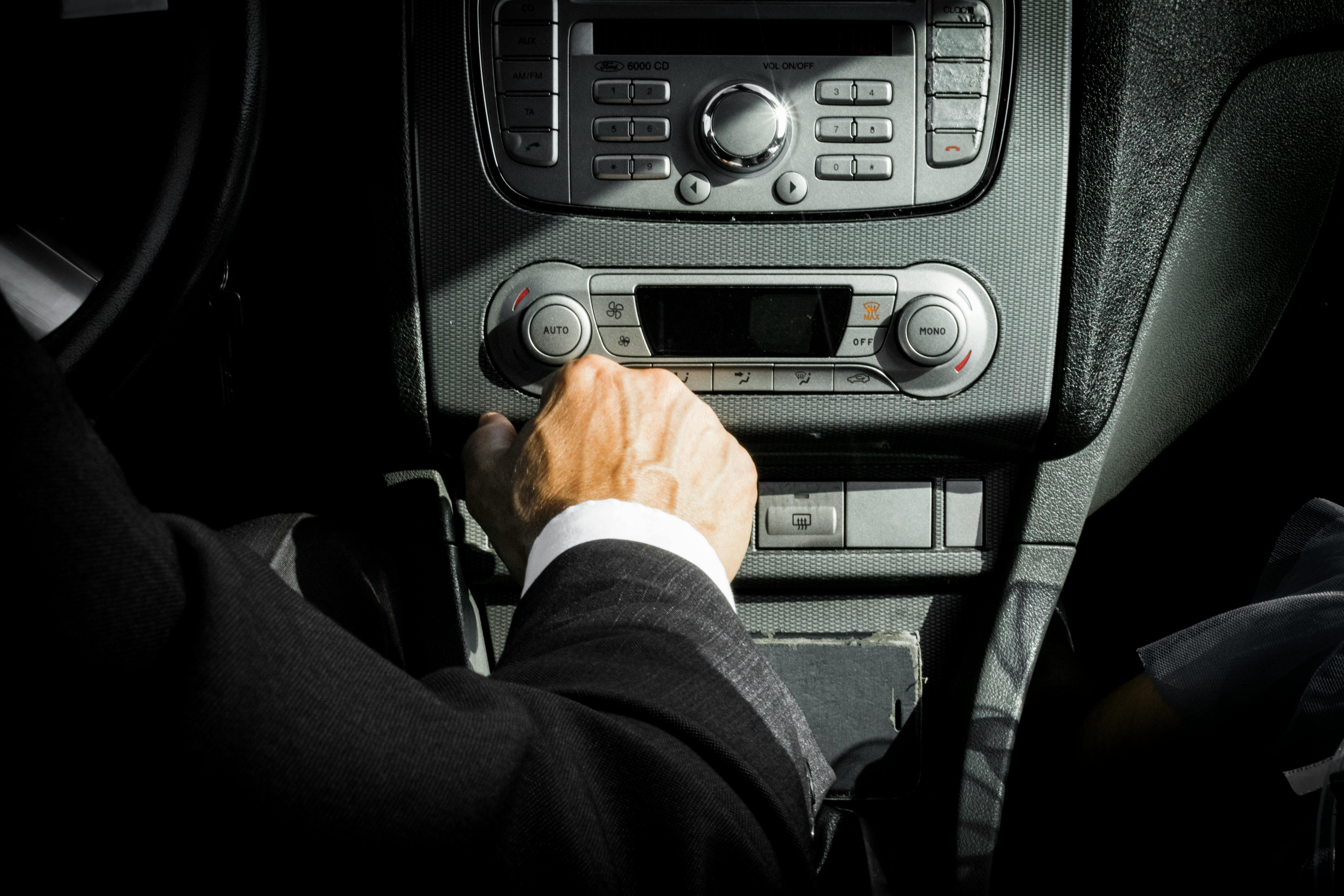 man in black suit inside car