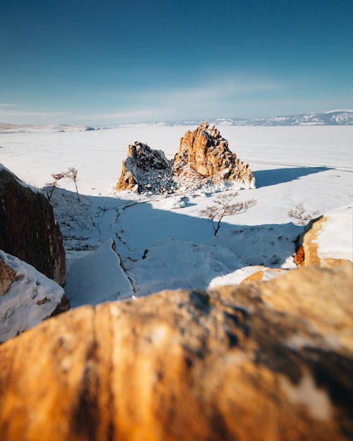 Free Brown Rock Formation on Snow Covered Ground Under Blue Sky Stock Photo