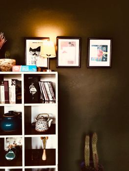 Cozy home interior with bookshelf and framed art in Van, Turkey.