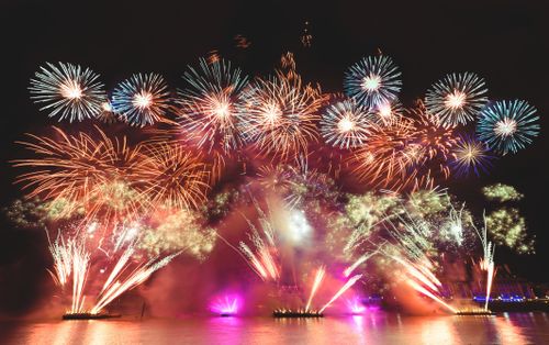 Free Experience the vibrant fireworks show lighting up the night sky over London's iconic London Eye. Stock Photo