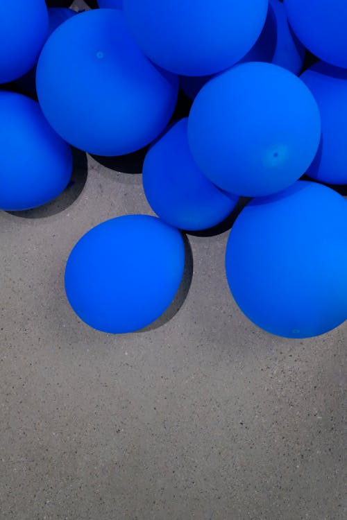 Blue Baloons on Pavement