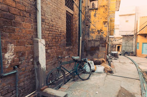 Free Old Brick Building with Bicycle parked in a Wall  Stock Photo