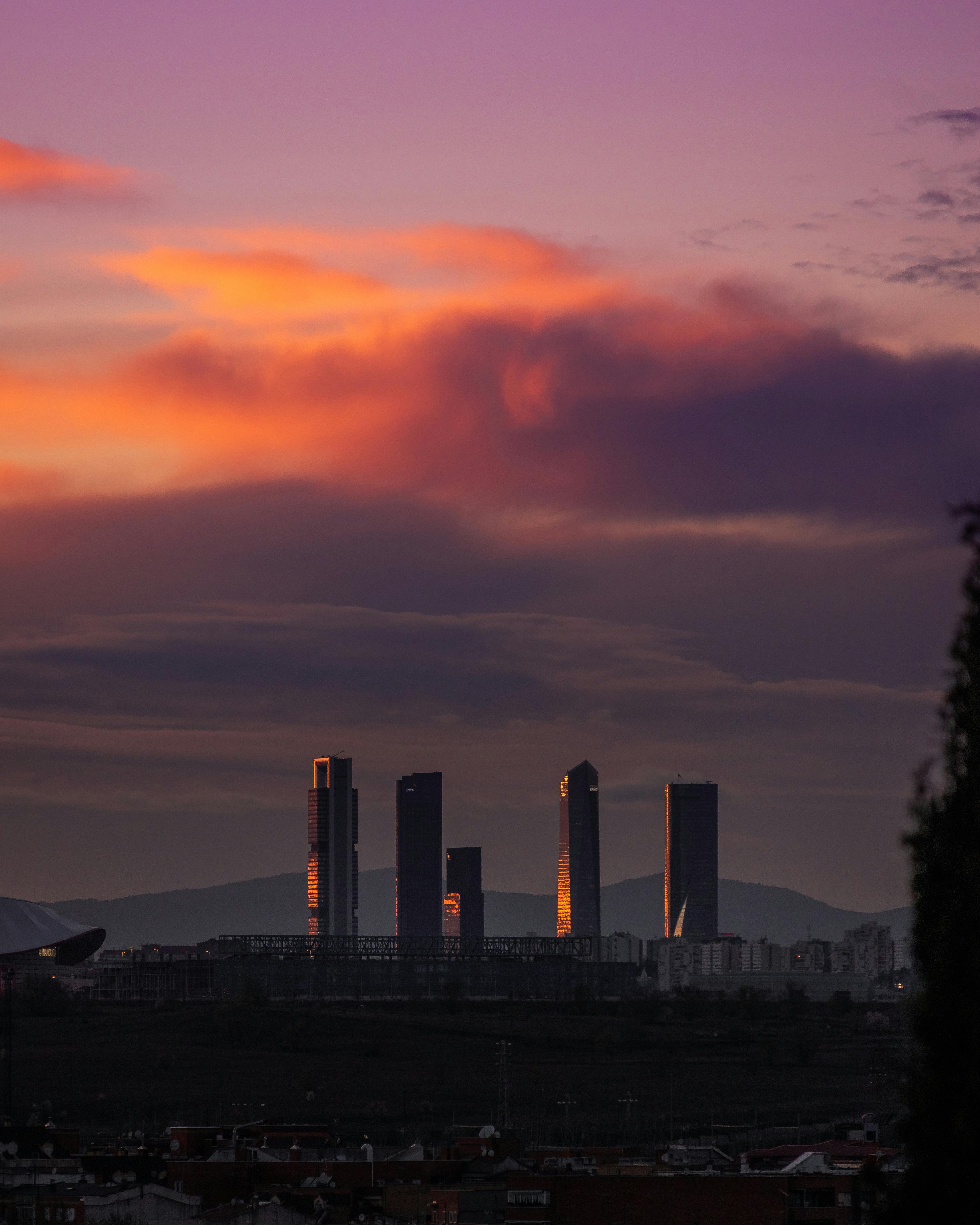 silhouetted skyscrapers of the business district of madrid spain at sunset