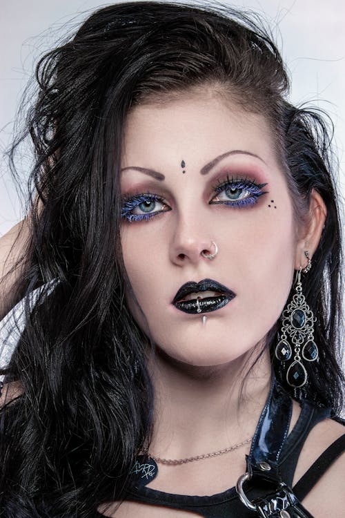 A Close-up Shot of a Woman with Black Lips and Hair