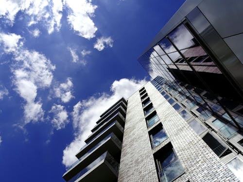 Free Low Angle of High-rise Building With Cloudy Sky Stock Photo