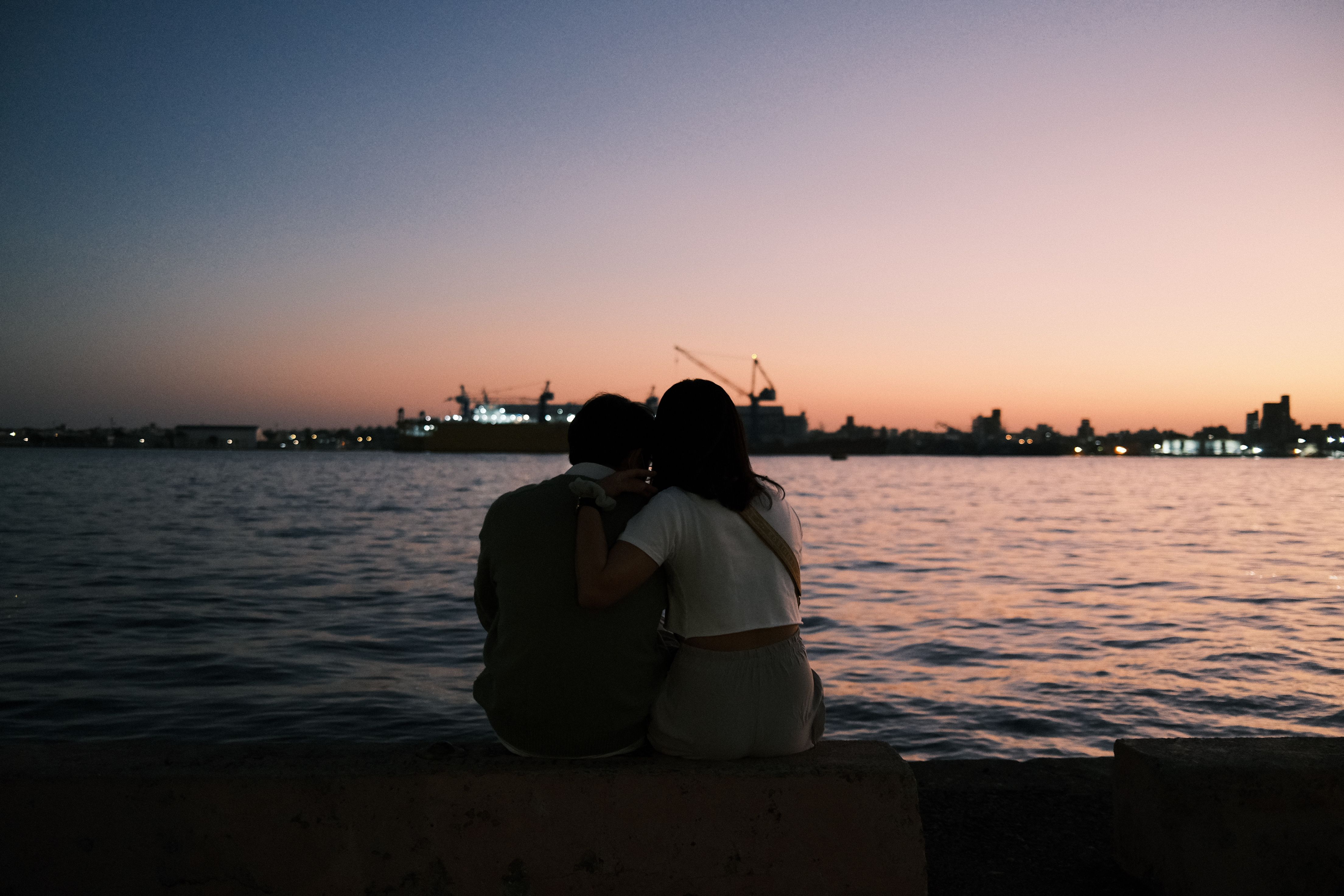 A couple enjoying a sunset by the waterfront in Kaohsiung