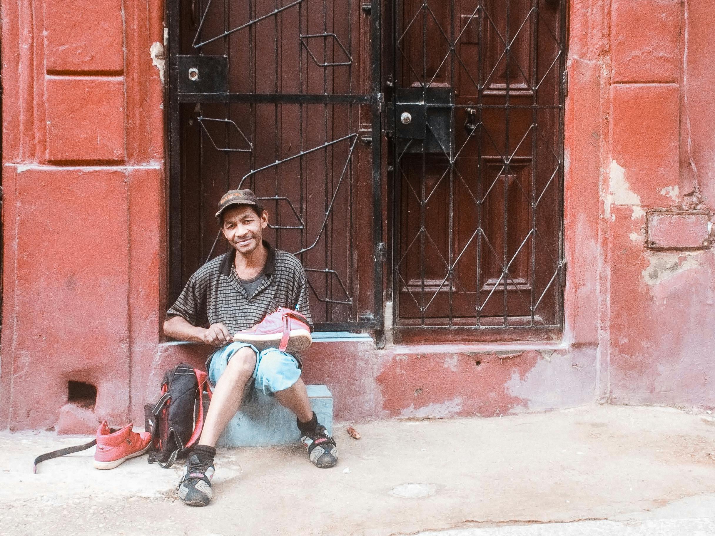 a man sitting with shoes