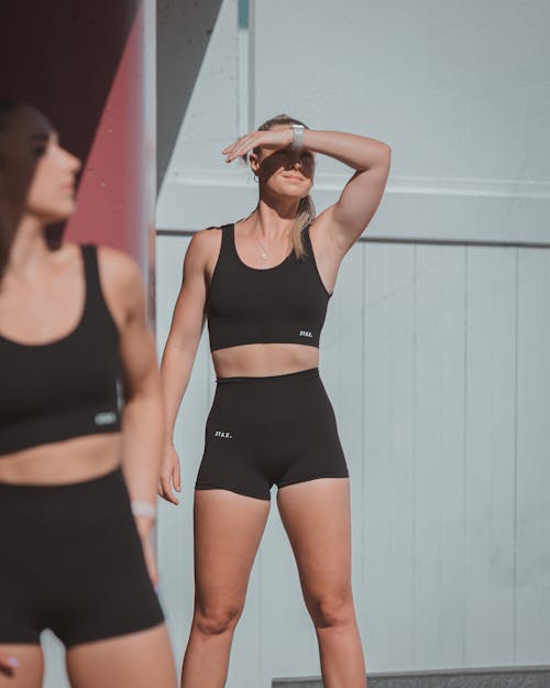 A Woman in Black Activewear Covering Her Face