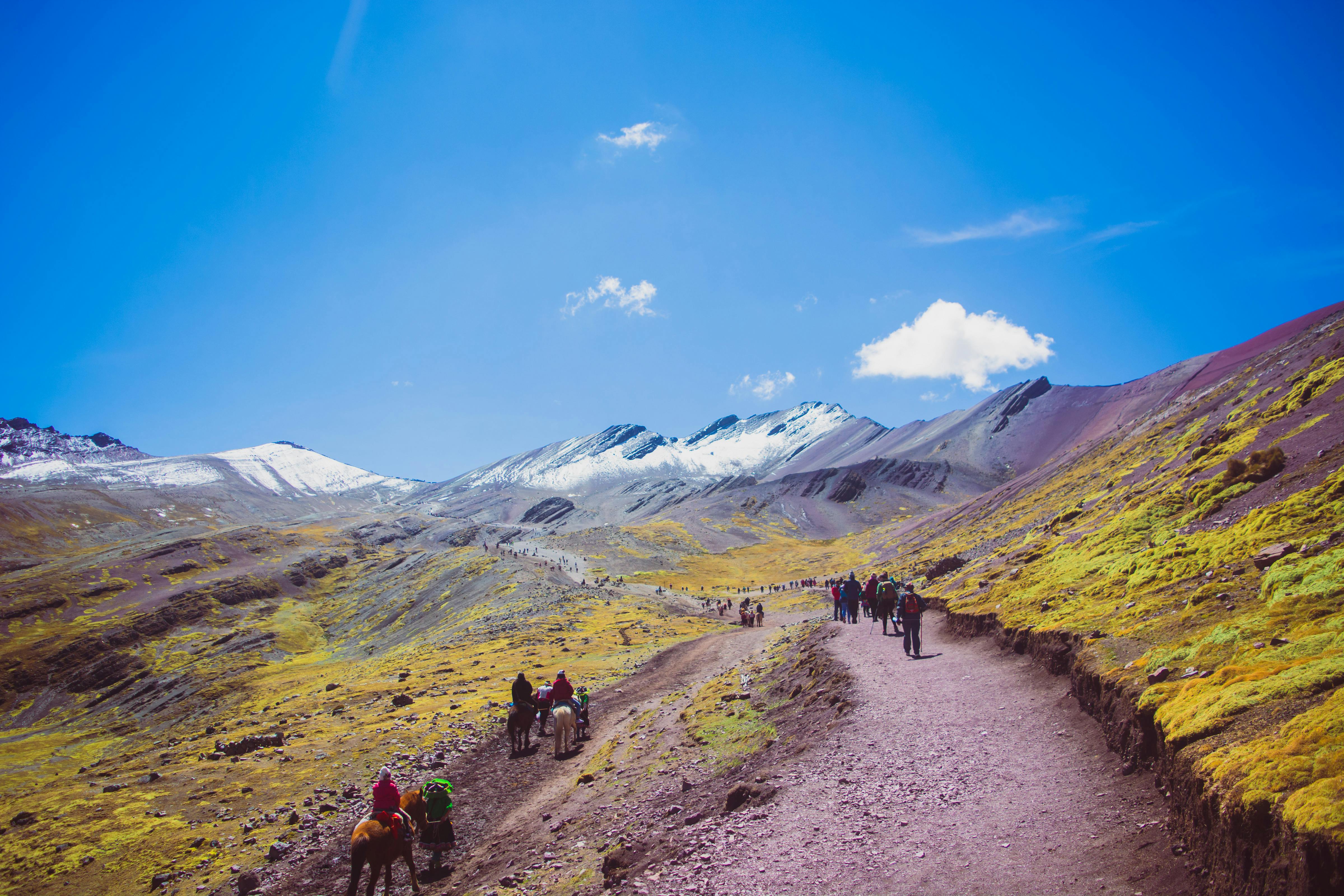 Explore the vibrant landscape of the Andes in Cuzco, Peru, featuring colorful mountains and hiking trails.
