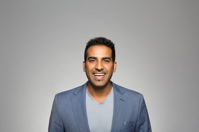 Portrait of a joyful man in a blue blazer
