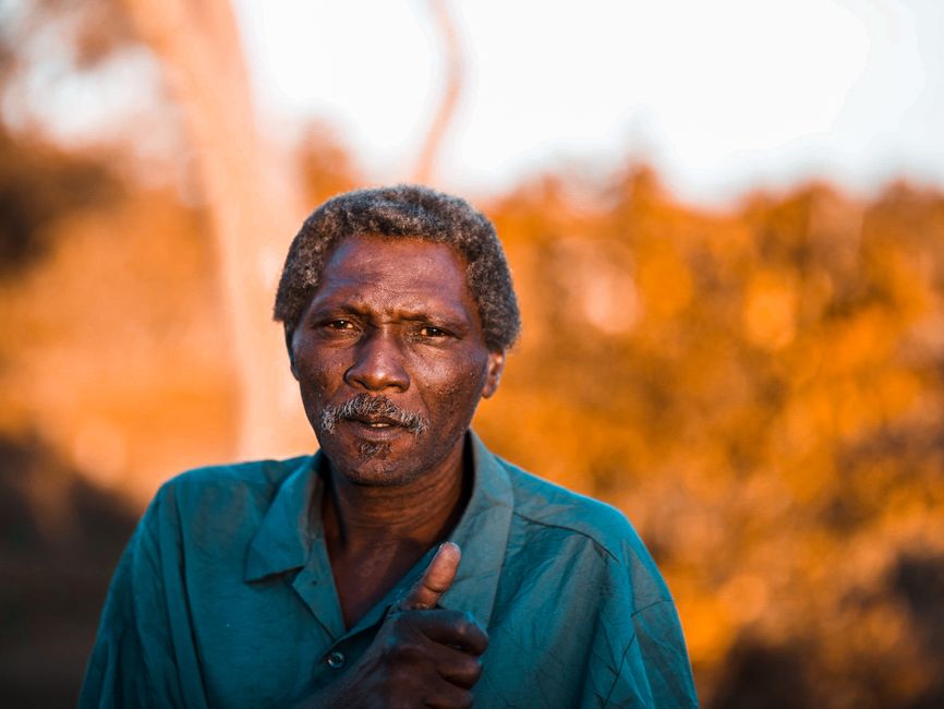 Close-up portrait of a middle-aged man outdoors in warm light.