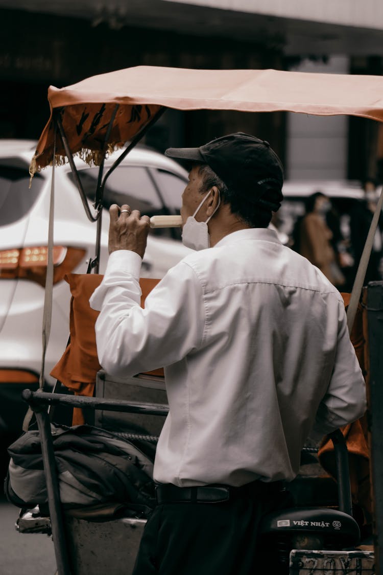 Man In White Long Sleeve Eating Popsicle Ice Cream