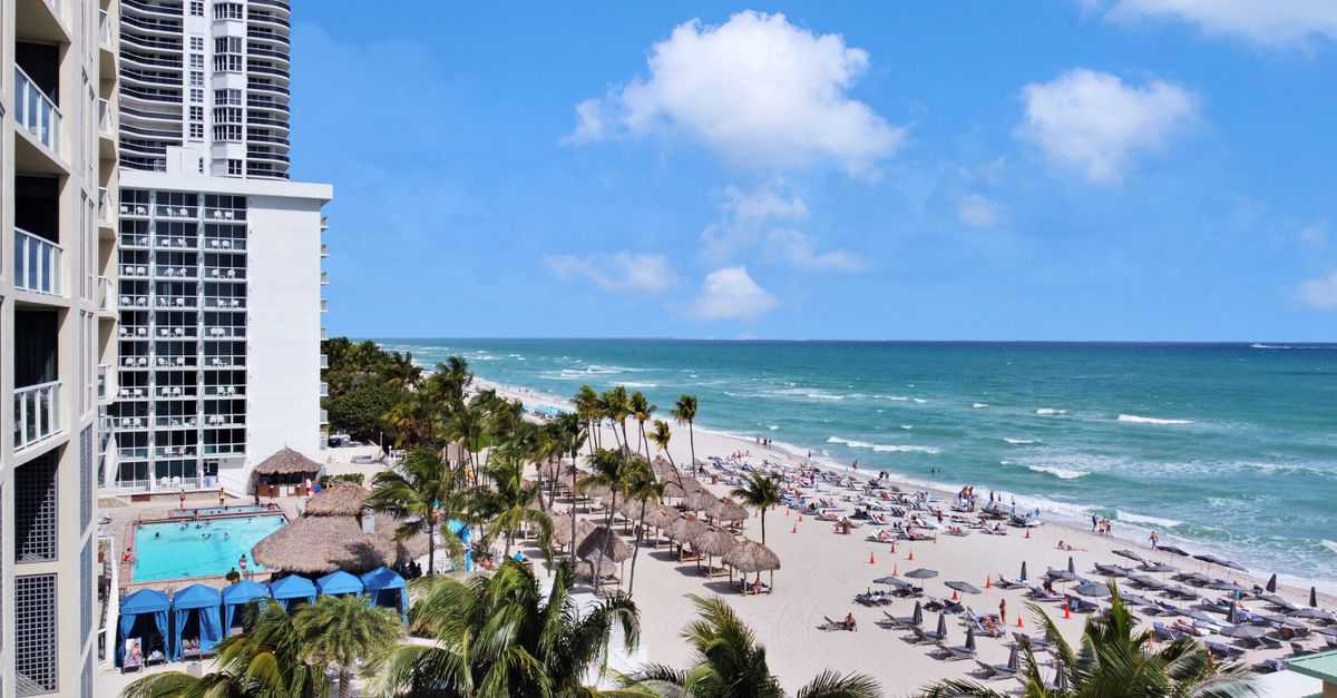 Experience the luxury of Sunny Isles Beach with ocean views, palm trees, and resort amenities.