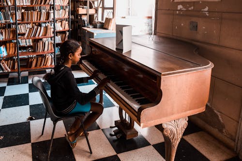 Free A Little Girl Playing the Piano Stock Photo