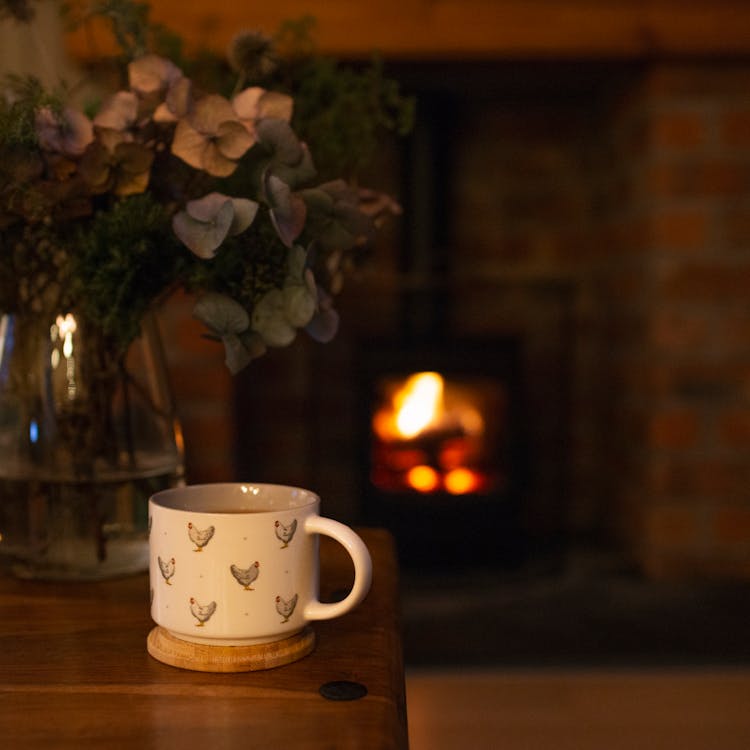 White Ceramic Mug On Wooden Coaster