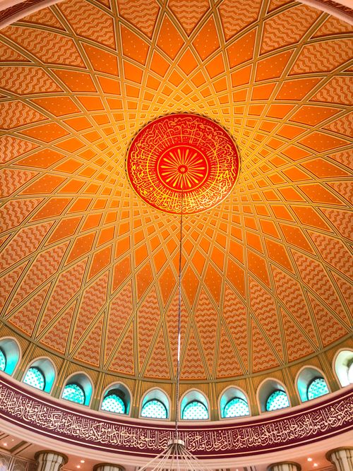 Free Capture of an intricately designed dome with vibrant colors and Arabic calligraphy. Stock Photo