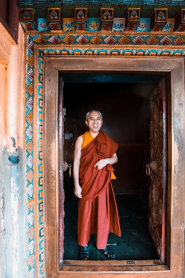 Monk Smiling In Door