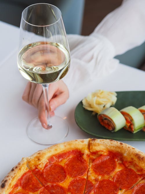 Free A Glass of Wine and Pizza  Stock Photo