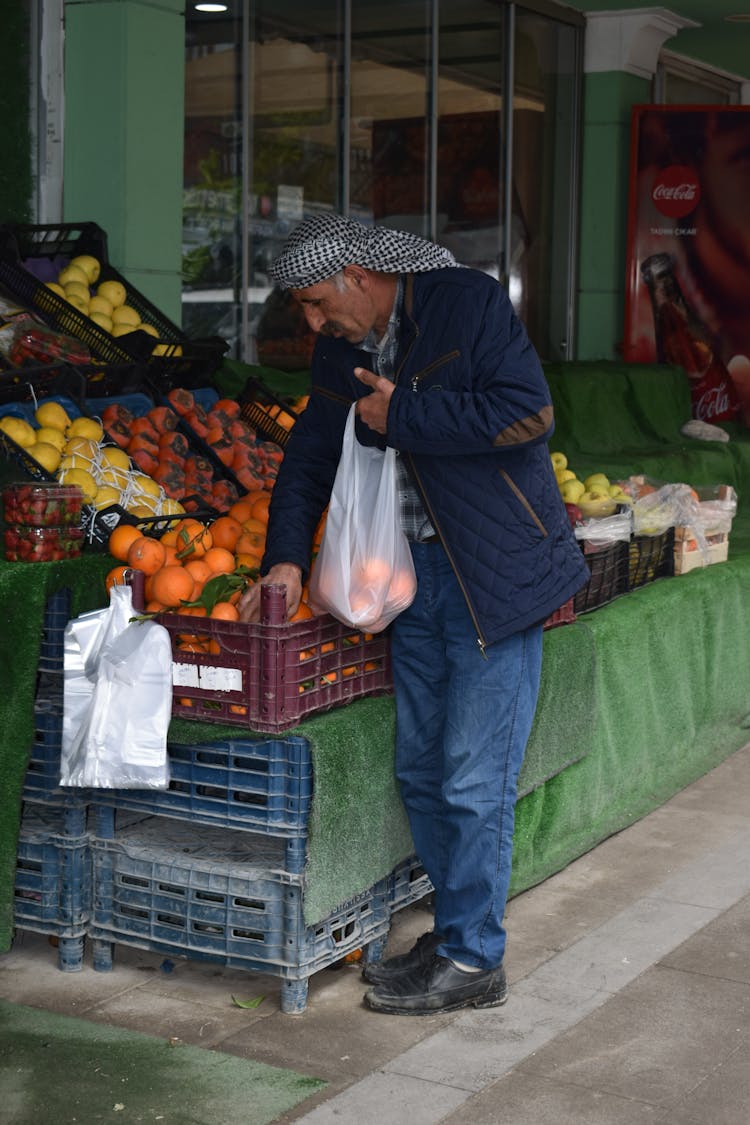 An Elderly Man Shopping At A Fruit Stand