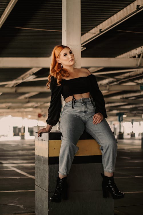Free Stylish Woman sitting in a Concrete Footing  Stock Photo
