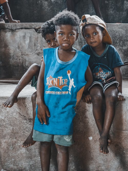 Children sitting and leaning in a Concrete Surface 