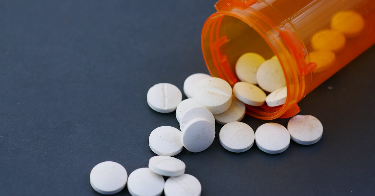 Pill Organizer With Loose Pills And Prescription Bottles On A Table