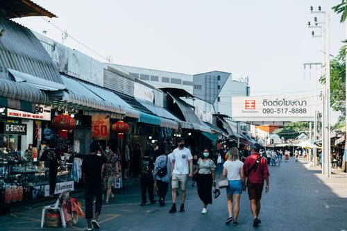 Free Lively Bangkok street market with diverse crowd shopping amid stalls. Captures the essence of urban commerce. Stock Photo