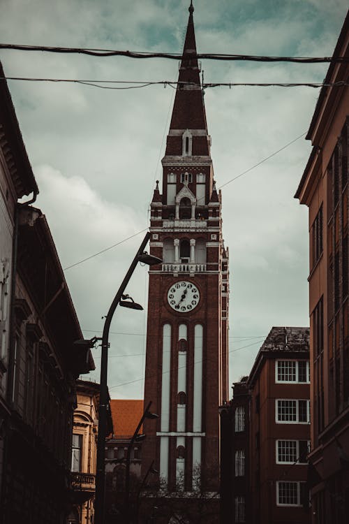 Old Clock Tower under Cloudy Sky 