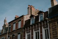 A picturesque view of classic European brick buildings with blue sky background.