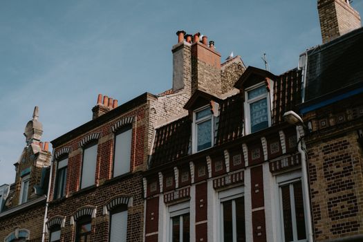 A picturesque view of classic European brick buildings with blue sky background.