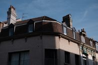 A low angle shot of a historic brick building facade under clear blue skies.