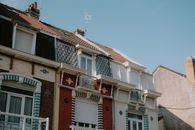 Capture of a charming European-style residential building with architectural details under a clear sky.