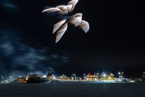 Illuminated Village on Shore at Night