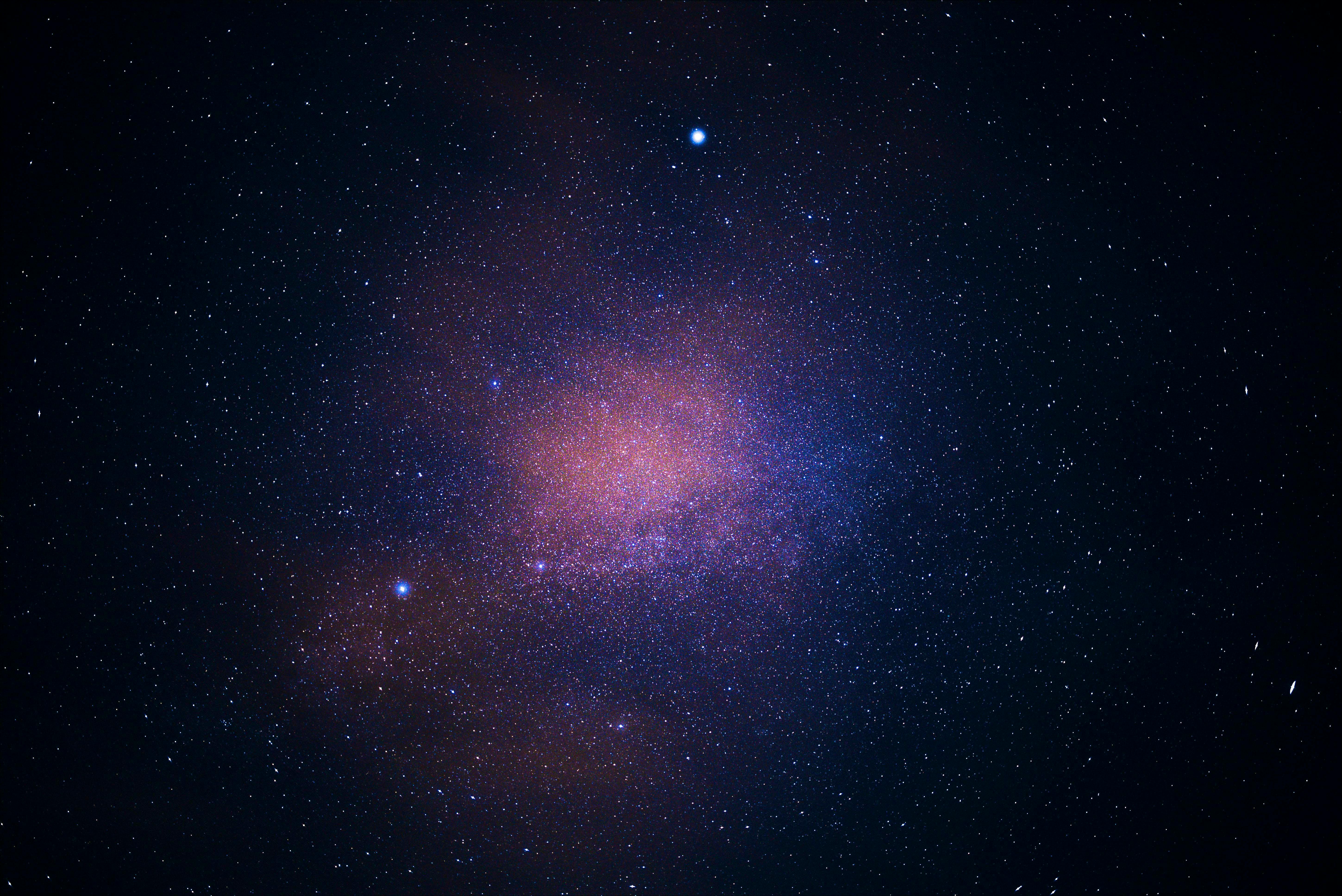 A stunning view of the galaxy cluster illuminating the starry sky, capturing the essence of the universe.