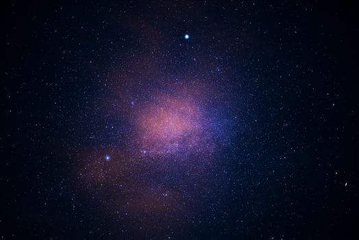 A stunning view of the galaxy cluster illuminating the starry sky, capturing the essence of the universe.