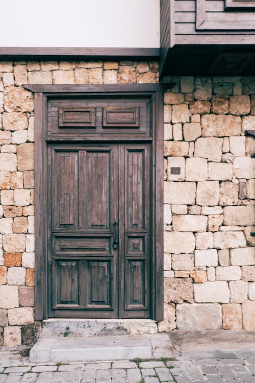 Black Wooden Door on Stone Wall