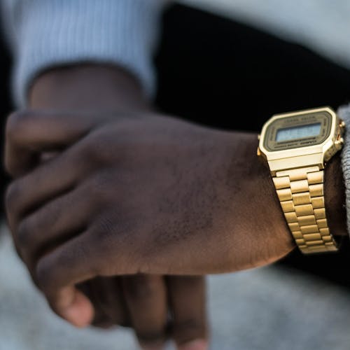 Person Wearing Gold-colored Casio Digital Watch With Linked Strap