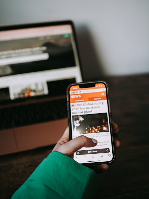 A Person Reading News in the cellphone