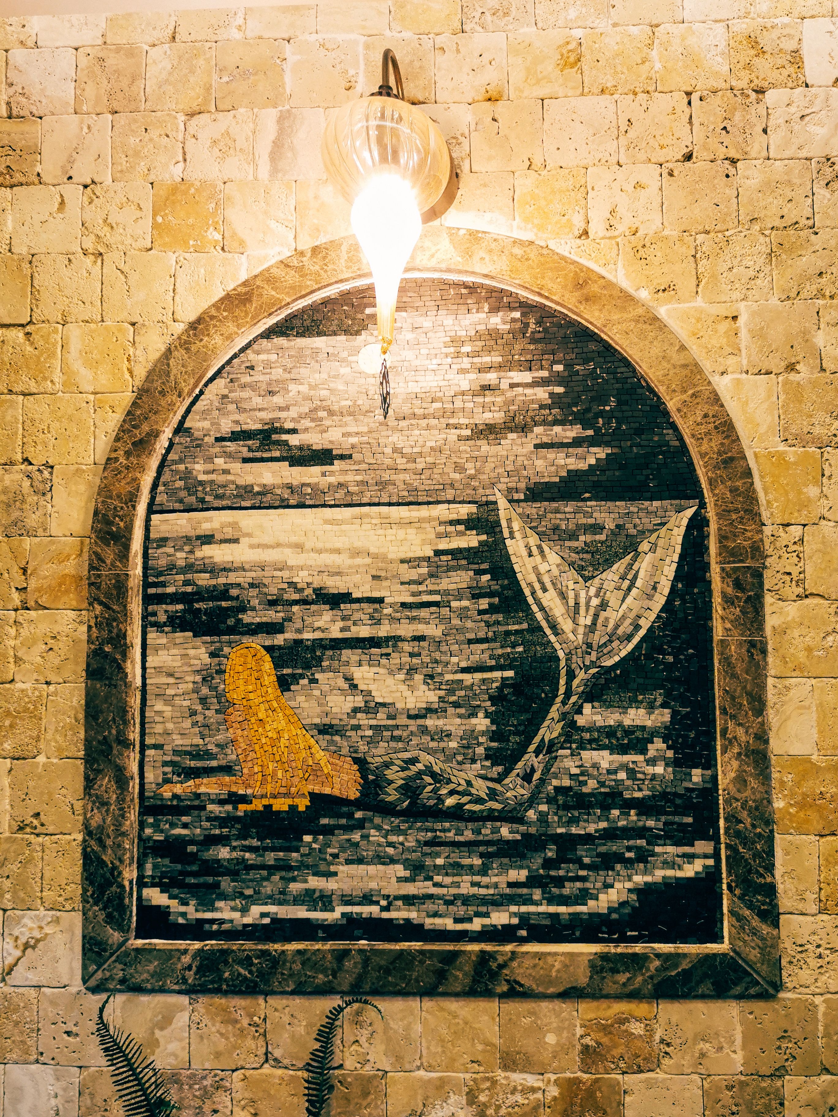 Beautiful mosaic depicting a mermaid on a stone wall in Arsuz, Hatay, Turkey.