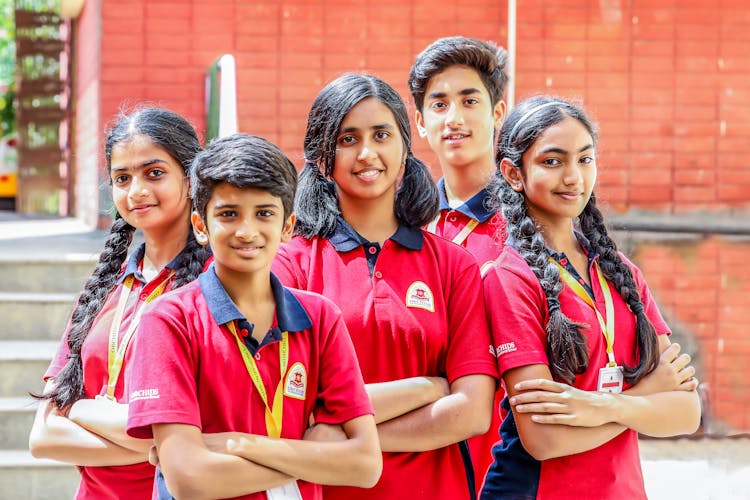 Group Of Students Wearing Red Polo Shirts