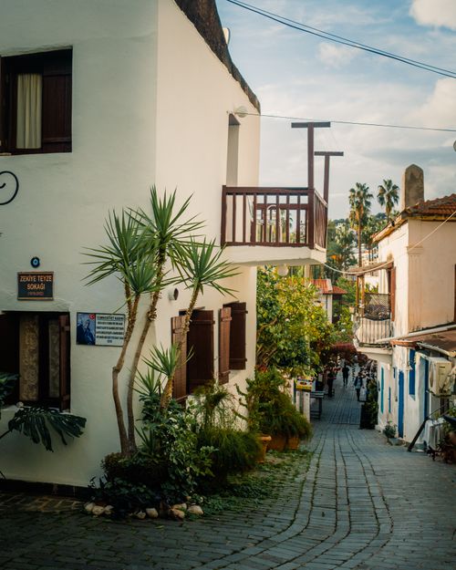 Free Explore the picturesque narrow streets of Antalya, Türkiye with traditional architecture and lush greenery. Stock Photo