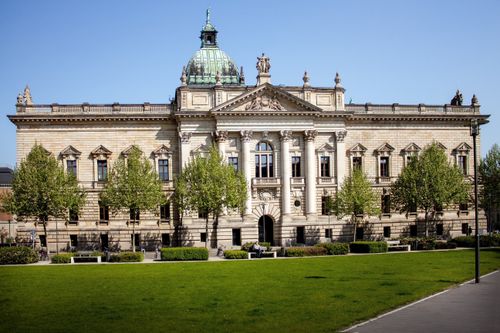 Free Front view of the Federal Administrative Court in Leipzig, Germany with a green lawn and clear sky. Stock Photo