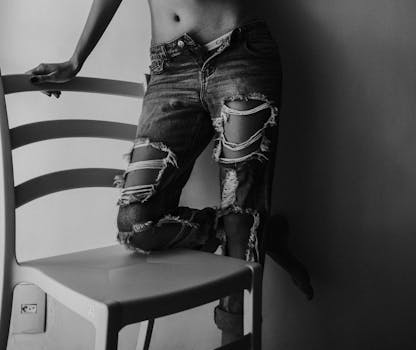 Grayscale Photography Of Person Wearing Distressed Jeans