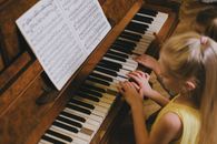 Boy in Yellow Tank Top Playing Piano