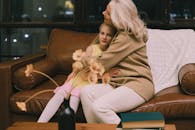 Woman in Brown Long Sleeve Shirt Sitting on Brown Couch