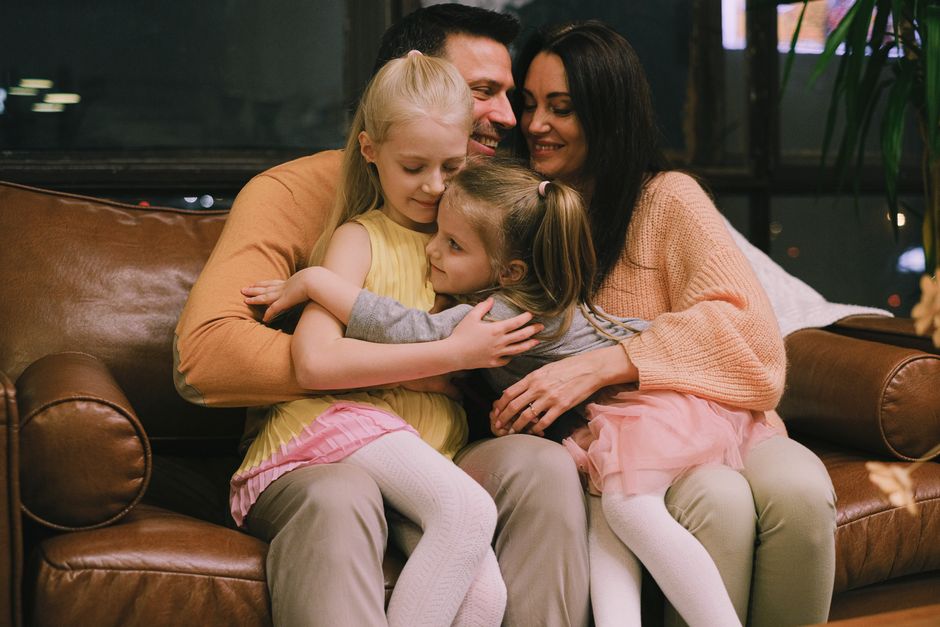 Photo by Anna Shvets on Pexels A joyful family shares a warm embrace on a comfortable leather sofa at home. - Photo by Anna Shvets on Pexels