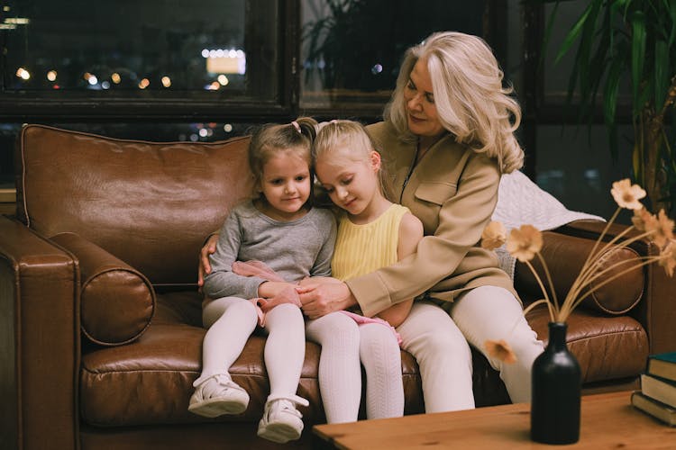 Woman Sitting On Sofa With Grandchildren