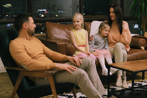 Free A Family Sitting Together in a Living Room Stock Photo