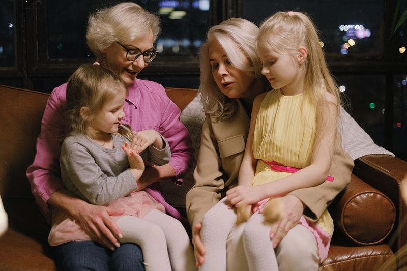 A family sitting together on a sofa at home