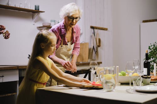 Free An Elderly Woman Preparing Food with her Granddaughter Stock Photo